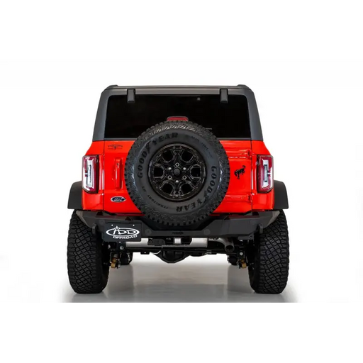 Red Jeep with black tire cover, Addictive Desert Designs Ford Bronco Rock Fighter Rear Bumper