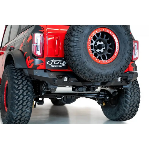 Red Jeep with black bumper and tire cover - Addictive Desert Designs Bomber Rear Bumper