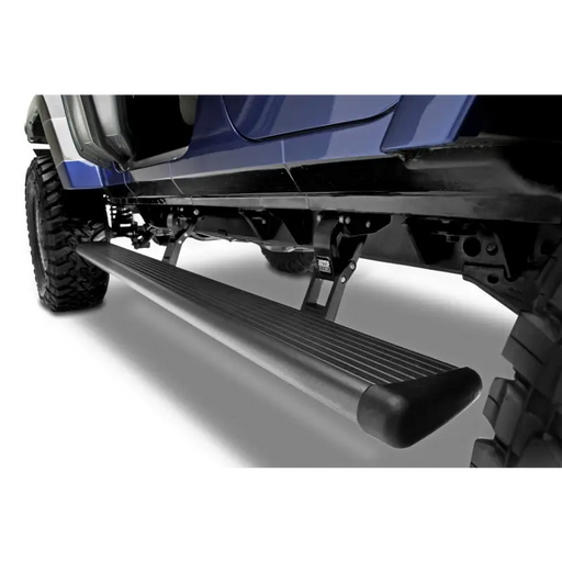 Close up of blue Jeep Wrangler JK 4 Door PowerStep front bumper bar by AMP Research.