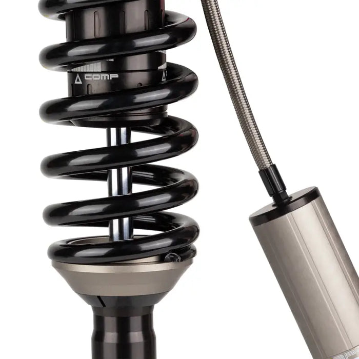 Close up of black and silver OME BP51 coilover shock absorber.