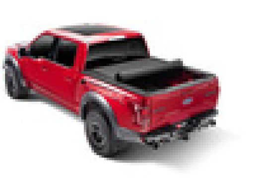 Red toy truck on white background next to bak 02-08 dodge ram revolver x4s 6.4ft bed cover