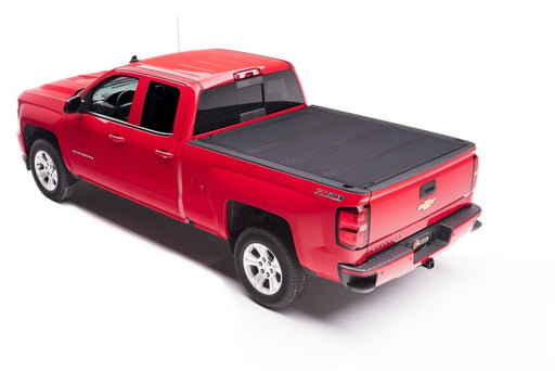 Red truck with black bed cover shown on bakflip mx4 matte finish product installation instructions