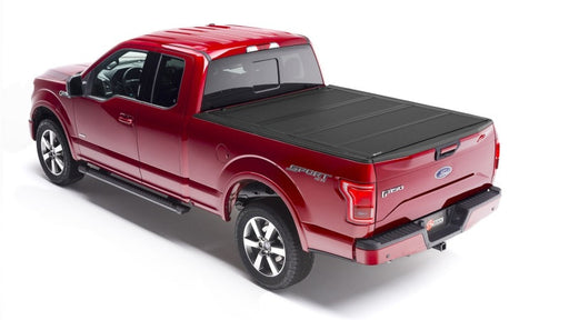 Red truck with black bed cover - bakflip mx4 for 04-14 ford f-150 6ft 6in bed