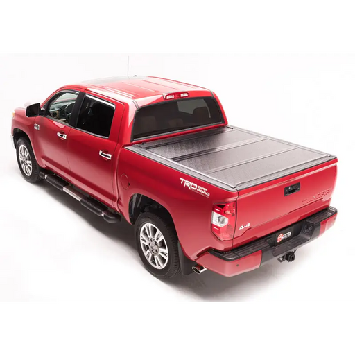 Red truck with black bed cover - BAK 16-20 Toyota Tacoma 5ft Bed BAKFlip G2.