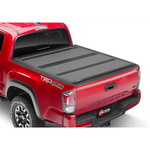 Red truck with BAK 16-20 Toyota Tacoma 6ft Bed BAKFlip MX4 Matte Finish.