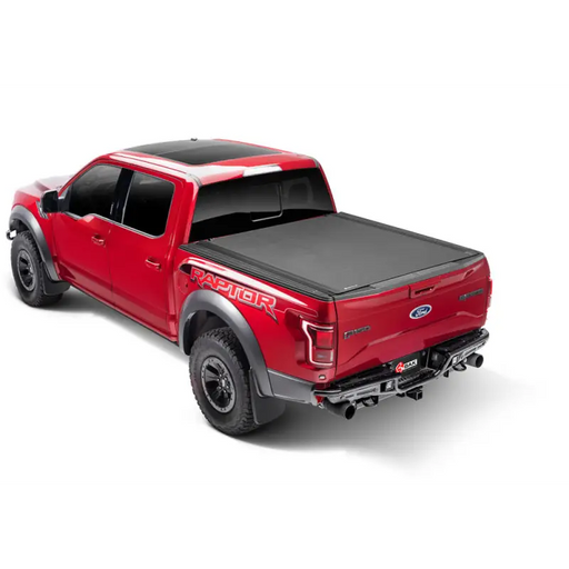 Red truck with black bed cover - BAK Revolver X4s for Toyota Tacoma
