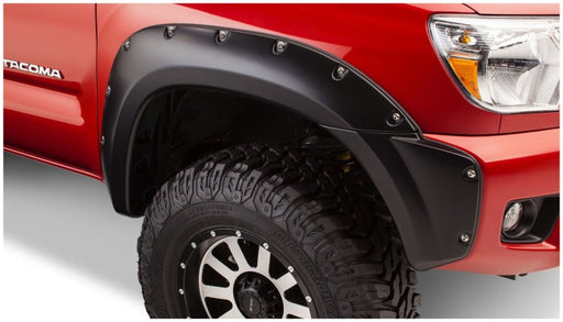 Close up of red truck with black fender showing bushwacker pocket style fender flares - toyota tacoma