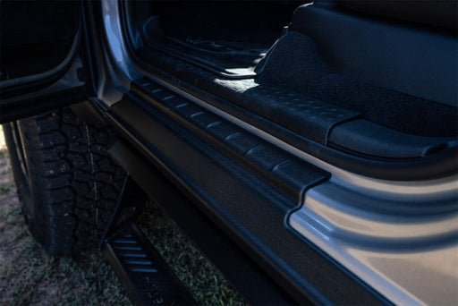 Close up of bushwacker 2021 ford bronco 2 door trail armor rocker panel in black, showing car door handle open