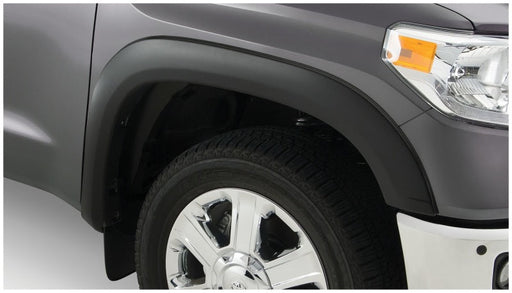 Close-up of front bumper plate on gray toyota tacoma fleetside with bushwacker fender flares