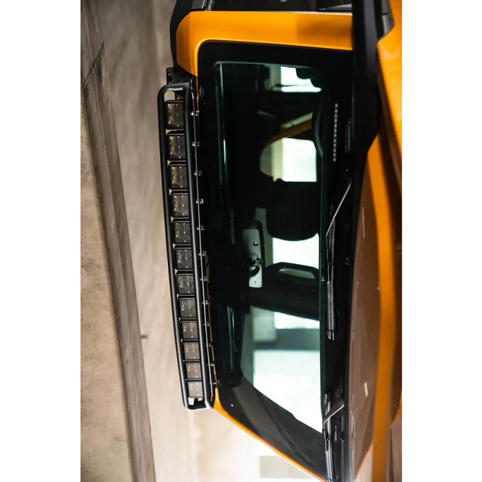 Yellow Ford Bronco front door with DV8 21+ Curved Light Bracket.