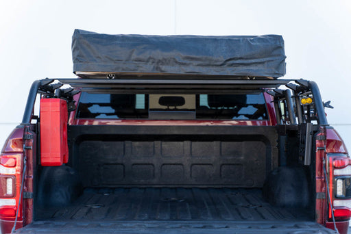 Red truck with black cover on back - dv8 offroad mto series bed rack