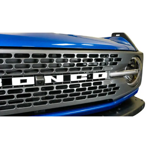 DV8 Offroad 2021+ Ford Bronco Adaptive Cruise Control Relocation Bracket showcasing blue truck with chrome grille.