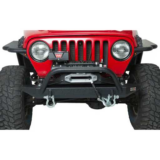 Black textured powdercoated front bumper with winch guard for Wrangler TJ Rubicon, displayed on red Jeep.