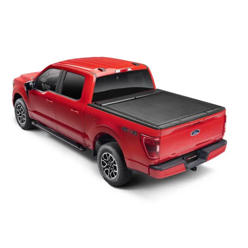 Red truck with black bed cover: Roll-N-Lock M-Series XT Retractable Cover for 20-22 Jeep Gladiator (w/o Trail Rail Sys -