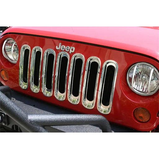 Rugged Ridge chrome grille inserts on red Jeep Wrangler