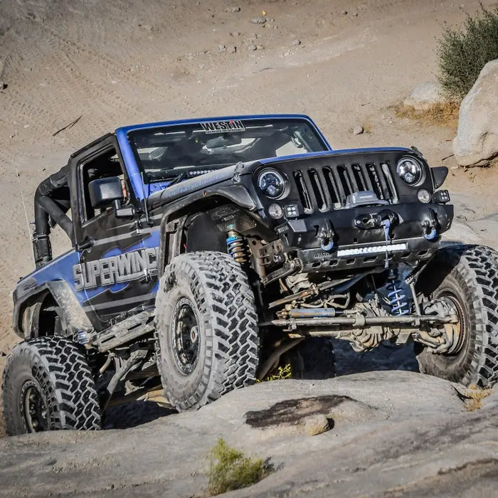 Superwinch 10000 LBS 12V DC 3/8in x 80ft Synthetic Rope SX 10000 Winch navigating rocky terrain in