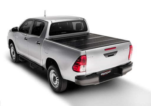 White toyota tacoma 5ft flex bed cover with black stripe - folding truck bed cover