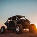Off-road vehicle parked on rocky road with rigid industries revolve light pod kit - pair.