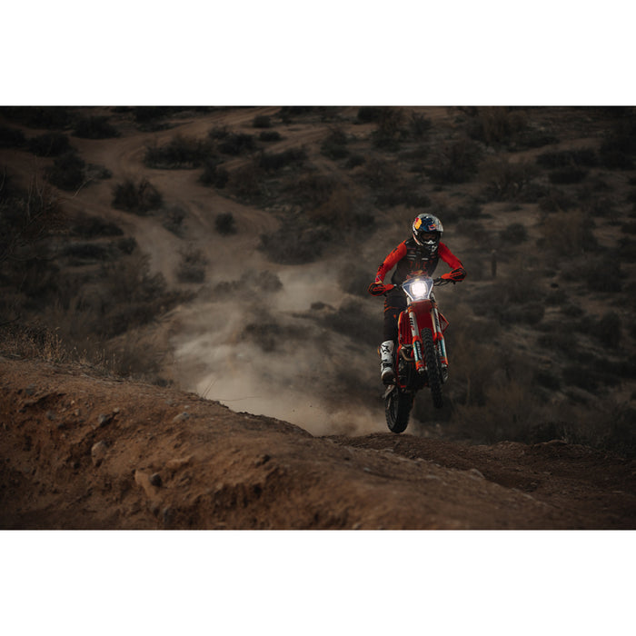 Person riding dirt bike on hill, fits rigid industries single light cover for adapt xp - black.