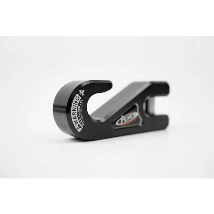 Black aluminum bottle opener on white background, by Addictive Desert Designs.