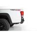 White truck with black rim and red tail light from Addictive Desert Designs Toyota Tacoma Stealth Fighter Rear Bumper.