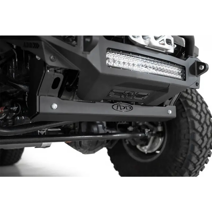 Black off-road vehicle with light accessory on skid plate by Addictive Desert Designs.