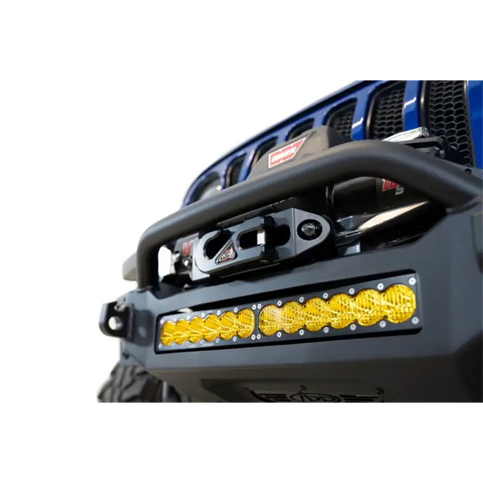 Blue jeep with yellow light - addictive desert designs rock fighter front bumper.