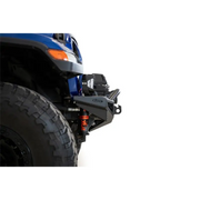 Blue truck with big tire on addictive desert designs rock fighter front bumper.