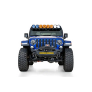 Blue jeep with lights on front bumper by addictive desert designs