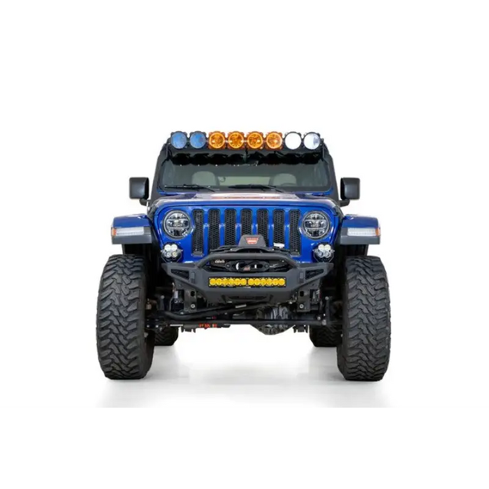 Blue jeep with lights on front bumper by addictive desert designs