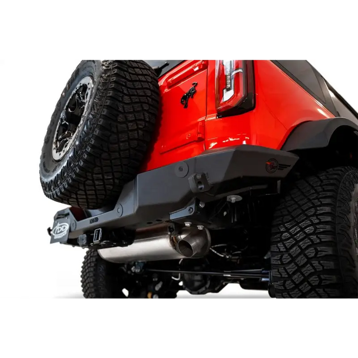 Red Jeep with black bumper and tire on Addictive Desert Designs 2021+ Ford Bronco Rock Fighter Rear Bumper - Hammer Black.