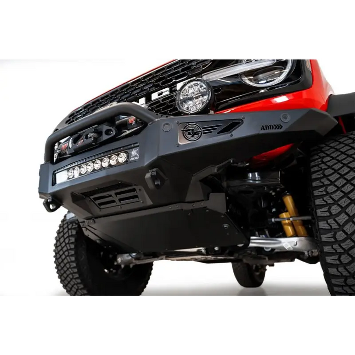 Close-up of red truck with large front bumper - Addictive Desert Designs Rock Fighter Skid Plate for Ford Bronco