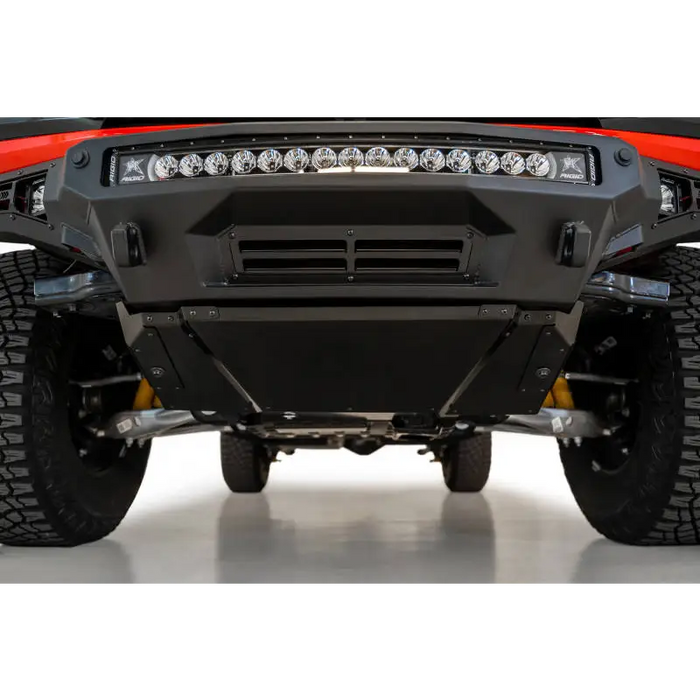 Red truck with light on skid plate kit by Addictive Desert Designs.
