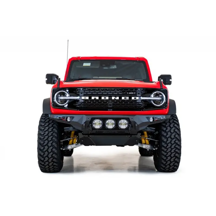 Red truck with big front bumper on Addictive Desert Designs Ford Bronco Bomber Front Bumper, satin black.