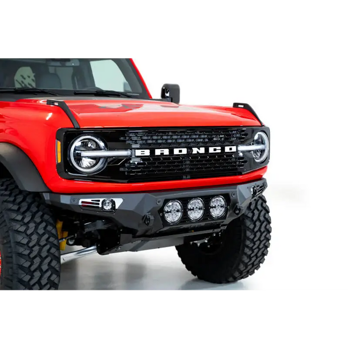 Red truck with black bumper and Addictive Desert Designs 21-22 Ford Bronco Bomber Front Bumper in satin black.
