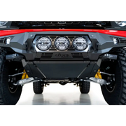 Red ATV with black bumper, compatible with Addictive Desert Designs skid plate for Ford Bronco Bomber.