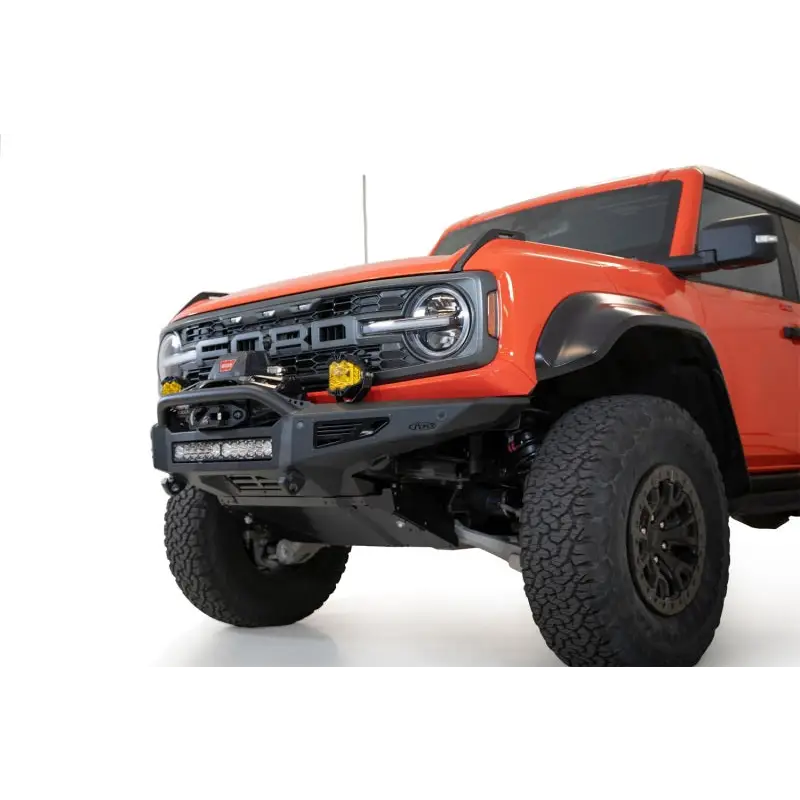 Red truck front end with Addictive Desert Designs 22-23 Ford Bronco Raptor Rock Fighter Skid Plate.
