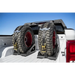 Rear view of white truck with two tires on Universal Tire Carrier.