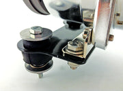 Close up of sewing machine button on air lift compressor isolator bracket kit
