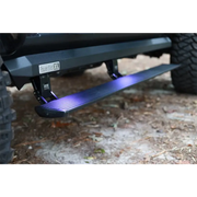 Black Jeep Wrangler JL front bumper plate with blue LED illumination.