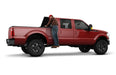 Man standing in back of red chevrolet silverado truck - amp research bedstep2 - black