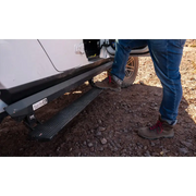 Man standing next to white van with AMP Research Jeep JT Gladiator PowerStep XL - Black.