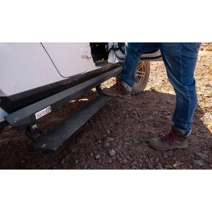 Man standing next to white van with AMP Research Jeep JT Gladiator PowerStep XL - Black.