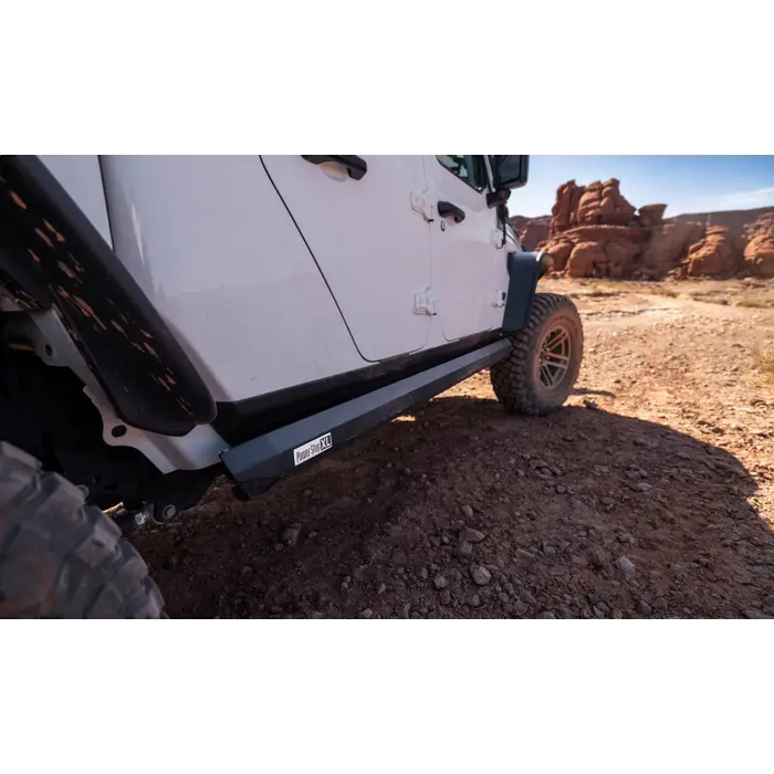 AMP Research PowerStep XL installed on a Jeep JT Gladiator parked on dirt road