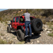 Man installing tire on Jeep Wrangler with AMP Research BedStep - Black