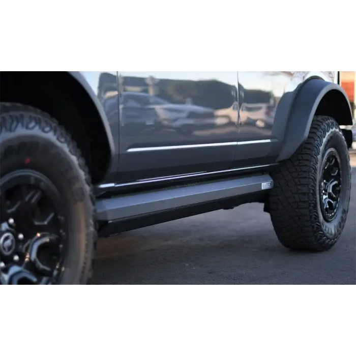 Black truck with tire cover - AMP Research Ford Bronco XL PowerStep