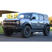 Gray truck parked in front of house - AMP Research Ford Bronco XL PowerStep Black