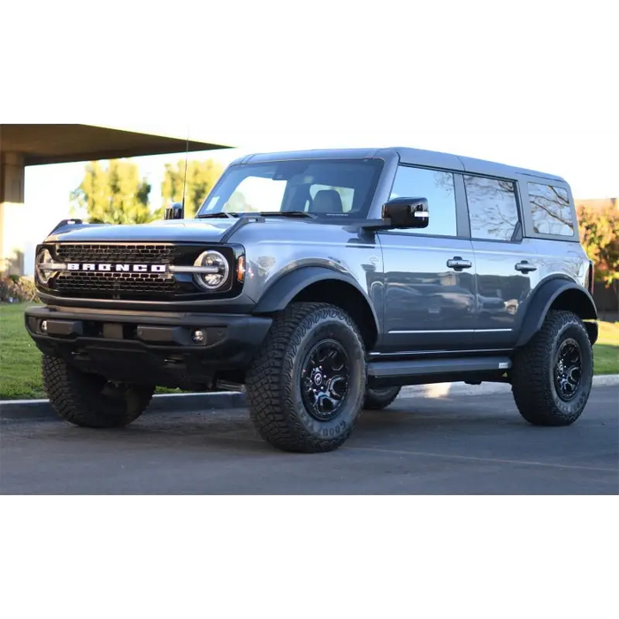 Gray truck parked in front of house - AMP Research Ford Bronco XL PowerStep Black