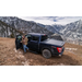 Man standing next to a truck on a mountain with AMP Research Powerstep Plug N Play - Black