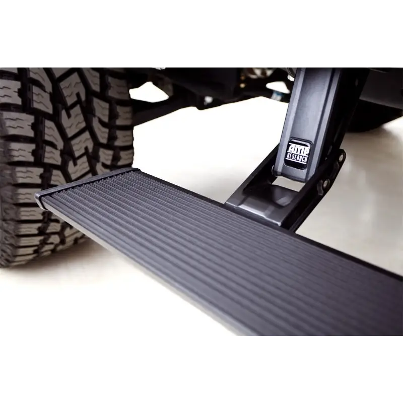 AMP Research PowerStep Xtreme Black truck with tire close up.